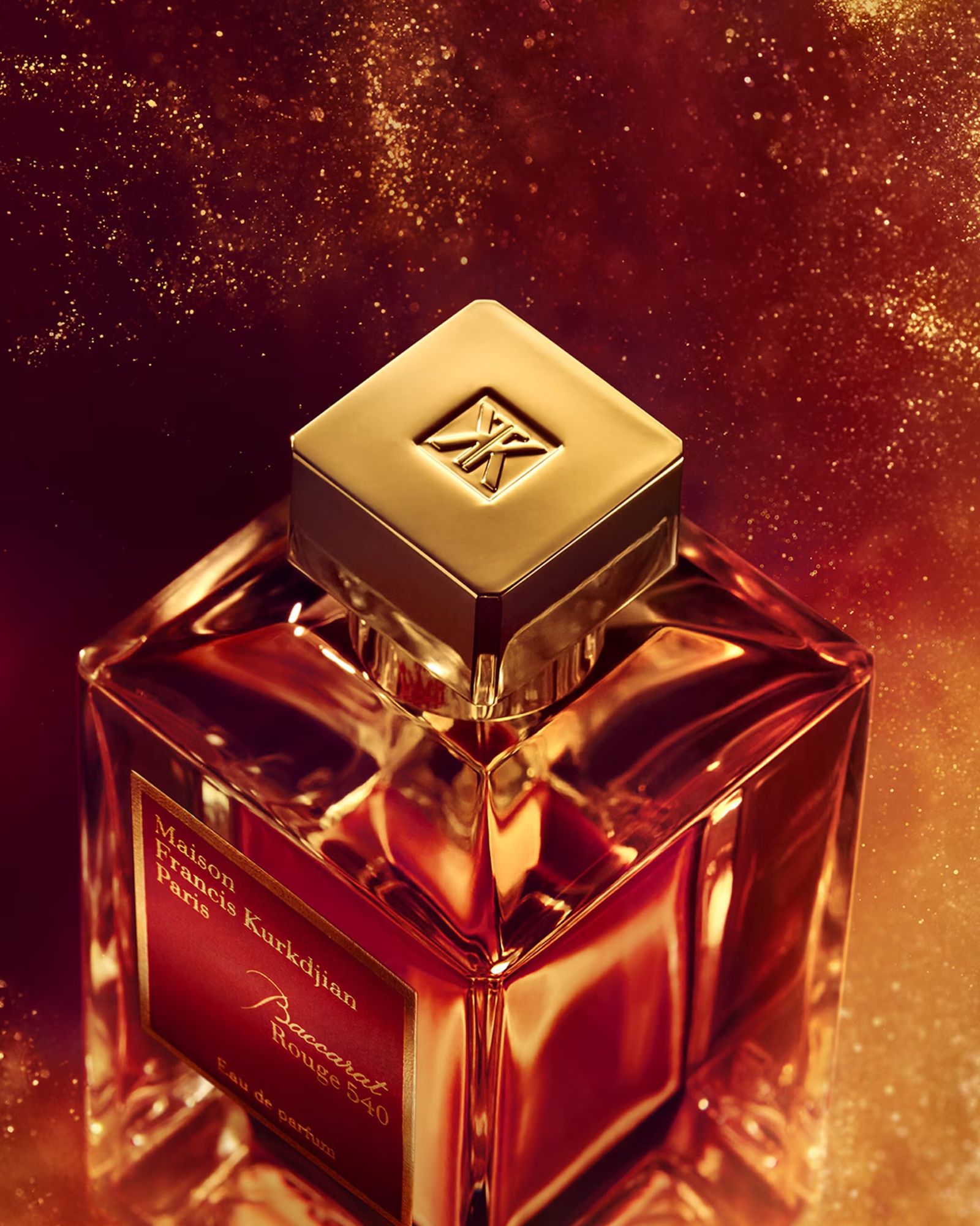 Luxurious perfume bottle with gold cap on a sparkling background