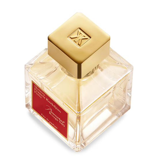 Perfume bottle with gold cap and red label on a white background